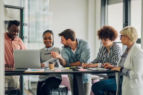 Team of office workers having a meeting around a desk